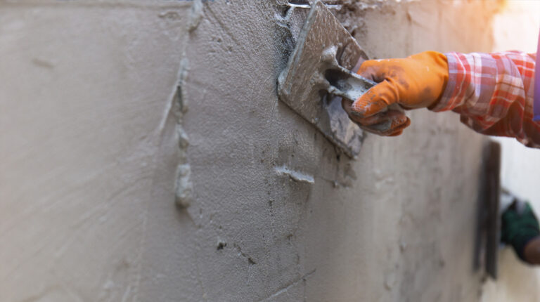 plasterers hands working on a wall